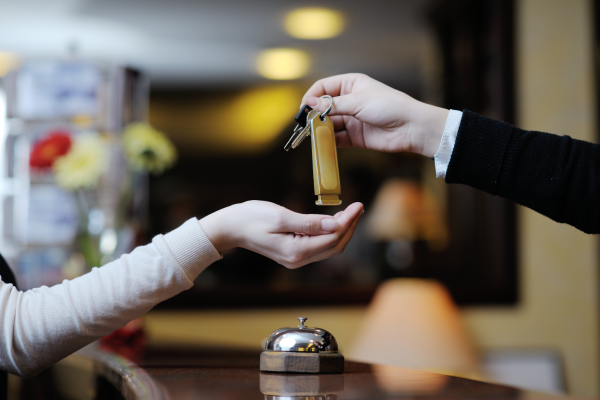 Guest being handed hotel room keys to show that bookings are increasing after the pandemic