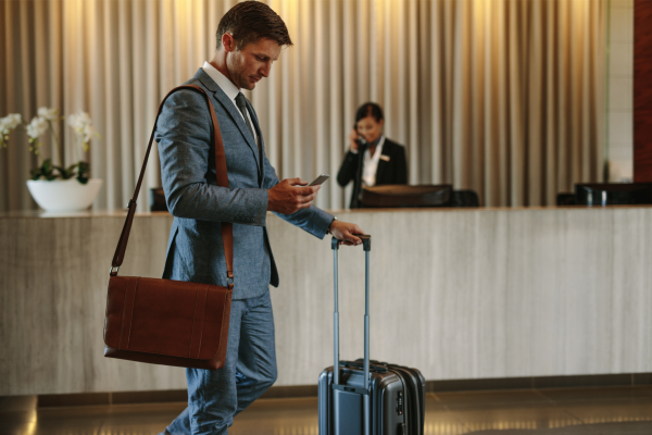 Businessman checking into a hotel to show that they prioritize business travelers