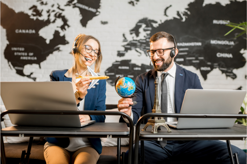 A man and a woman working for a Travel Management Agency