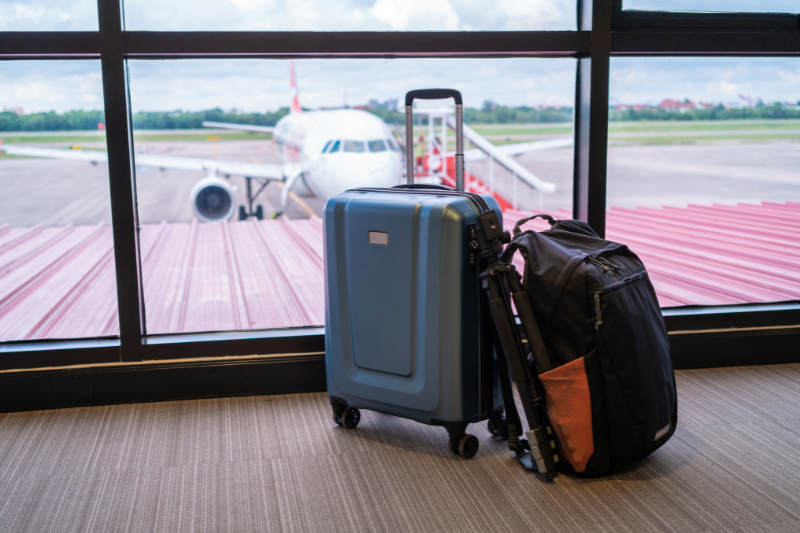 Lost luggage in front of the window of a plane